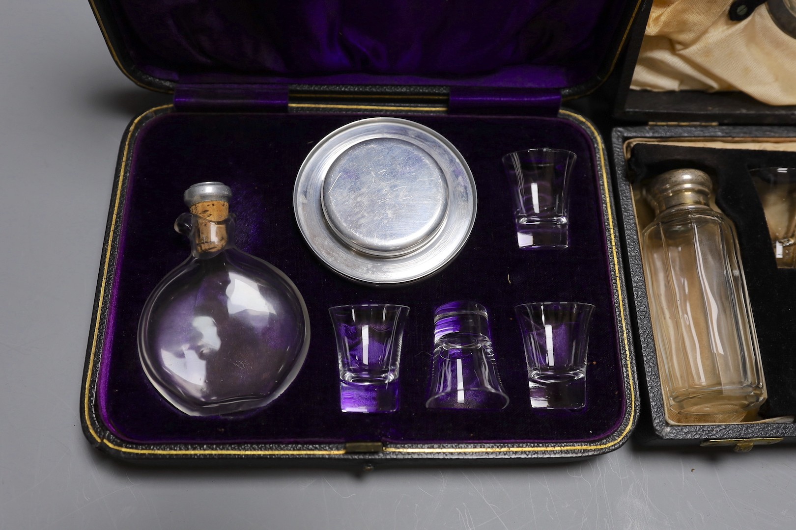 Three cased communion sets together with a mahogany box of slides